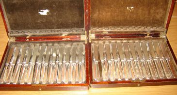 Photo of two cases of fish knives and forks