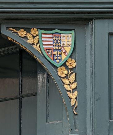 Photo of arms of college on shop