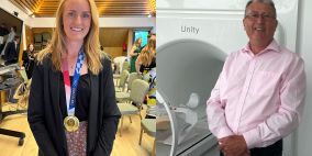 Woman on the left with gold medal and man on the right next to radiotherapy machine