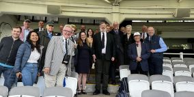 A group of people gathered in the stands at Lord's cricket ground